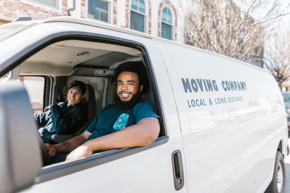 A friendly and professional moving company team preparing for a job